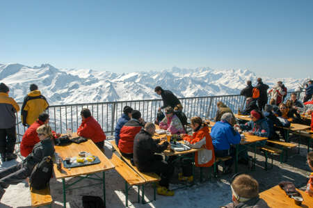 Engelberg, Switzerland - 28 March 2004: Sci tourists drinking and eating at the restaurant on mount Titlis over Engelgerg on the Swiss alpsのeditorial素材