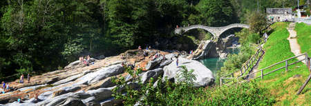 Lavertezzo, Switzerland: 1 September 2014: Tourists visiting the famous roman bridge of Lavertezzo on Verzasca valley on the italian part of Switzerlandのeditorial素材