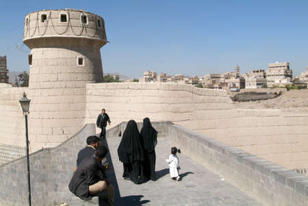 Sana, Yemen - 5 January 2008: people walking on the bridge near old Sana on Yemenのeditorial素材