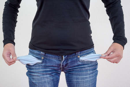 Woman showing empty pockets without money