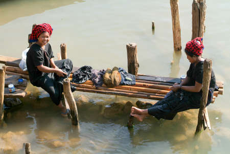 Indein, Myanmar - 15 January 2010: women washing clothes on the river at Indein on Inle Lake in Myanmarのeditorial素材