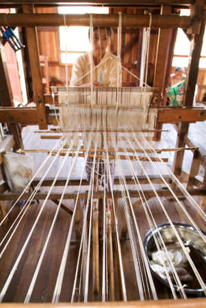 Lake Inle, Myanmar - 15 January 2010: Woman weaving a carpet with a loom at lake Inle on Myanmarのeditorial素材