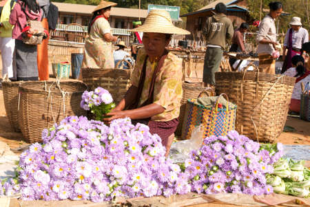 Indein, Myanmar - 15 January 2010: people on traditional clothes at the weekly market at Indein on Inle Lake in Myanmarのeditorial素材