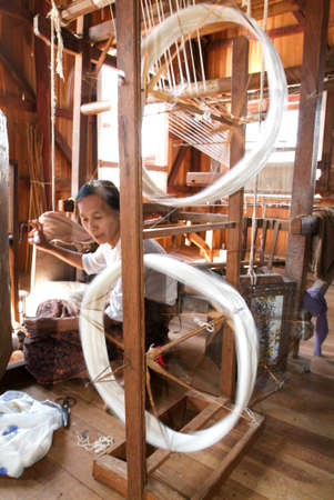 Lake Inle, Myanmar - 15 January 2010: Woman weaving a carpet with a loom at lake Inle on Myanmarのeditorial素材