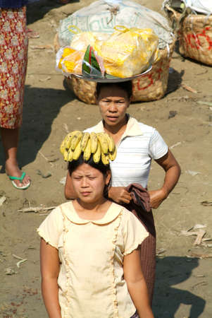River Ayeyarwady, Myanmar - 20 January 2010: People selling food on the Ayeyarwady river bank, Myanmarのeditorial素材