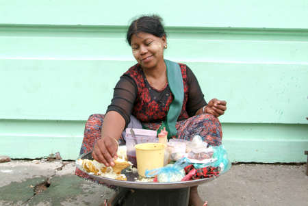 Yangon, Myanmar - 8 January 2010: street seller at the market of Yangon on Myanmarのeditorial素材