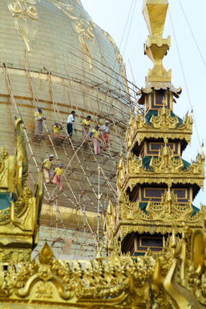 Yangon, Myanmar - 9 January 2010: Workers  repairing the stupa of the Shwedagon Pagoda in Yangon on Myanmarのeditorial素材