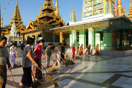 Yangon, Myanmar - 9 January 2010: People cleaning with brooms the area of the Shwedagon Pagoda in Yangon on Myanmarのeditorial素材
