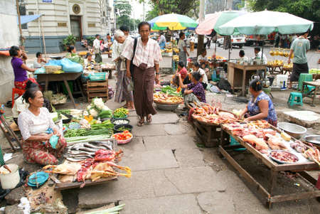 Yangon, Myanmar - 8 January 2010: street seller at the market of Yangon on Myanmarのeditorial素材