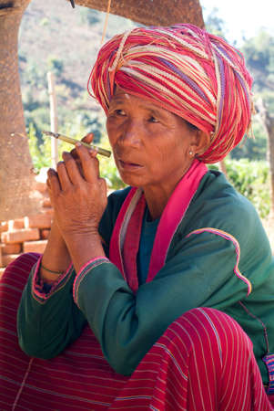 Joate (Kalaw), Myanmar - 12 January 2010: Woman smoking at the village of Joate on the mountains over Kalaw on Myanmarのeditorial素材