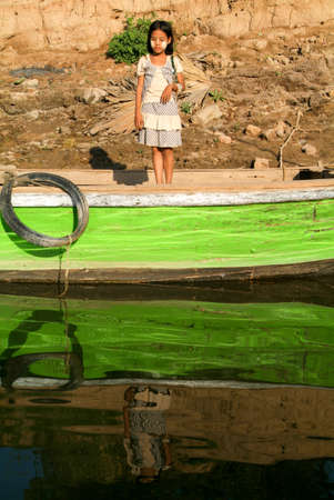 Inwa (Ava), Myanmar, 17 January 2010: Young girl on a boat at Inwa near Mandaley, Myanmarのeditorial素材
