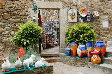 Pals, Spain - 16 July 2004: Tourists walting and shopping at a ceramic shop in Pals on Spain