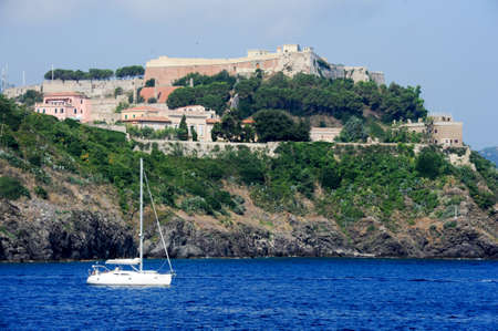 Portoferraio, Italy - 10 July 2011: Sailboat cruising in front of Portoferraio on Elba island, Italyのeditorial素材
