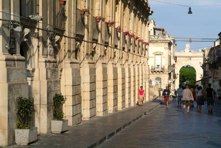 Noto, Italy - 21 July 2008: People walking on an alley of Noto on the island of Sicily, Italyのeditorial素材