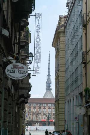 Turin, Italy - 15 July 2010: People walking on a street of Turin with at the bottom the Mole Antonelliana, Italyの写真素材