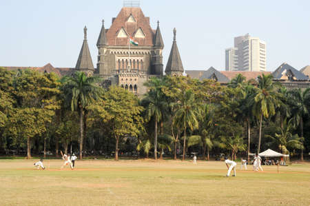 Mumbai, India - 5 january 2015: People playing cricket in the central park at Mumbai, Indiaのeditorial素材