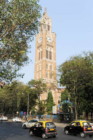 Mumbai, India - 5 january 2015: People walking in front of Rajabai Tower, historic clock tower at Bombay, Indiaのeditorial素材