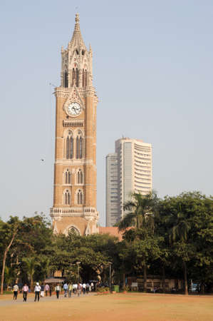 Mumbai, India - 5 january 2015: People walking in front of Rajabai Tower, historic clock tower at Bombay, Indiaのeditorial素材