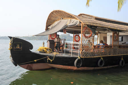 Kollam, India - 19 January 2015: Tourists cruising on a houseboat a river of the backwaters at Kollam on Indiaの写真素材