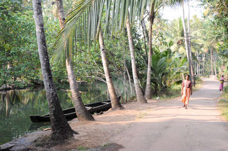 Kollam, India - 19 January 2015: People walking near a river of the backwaters at Kollam on Indiaのeditorial素材