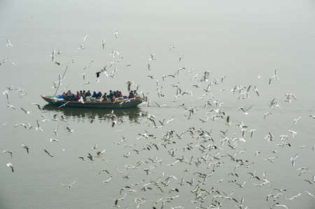 Varanasi, India - 28 January 2015: Indian tourists taking the popular boat tour on the sacred Ganges river in Varanasi, Uttar Pradesh, Indiaのeditorial素材