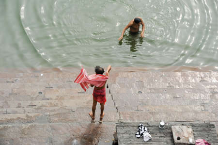 Varanasi, India - 28 January 2015: Hindu pilgrims take a holy bath in the river ganges in Varanasi or Benaresのeditorial素材