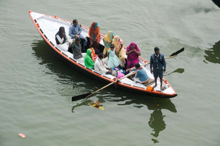 Varanasi, India - 28 January 2015: Indian tourists taking the popular boat tour on the sacred Ganges river in Varanasi, Uttar Pradesh, Indiaのeditorial素材
