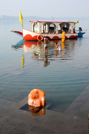 Maheshwar, India - 3 February 2015: Hindu pilgrims take a holy bath in the river Narmada at Maheshwar on Indiaのeditorial素材