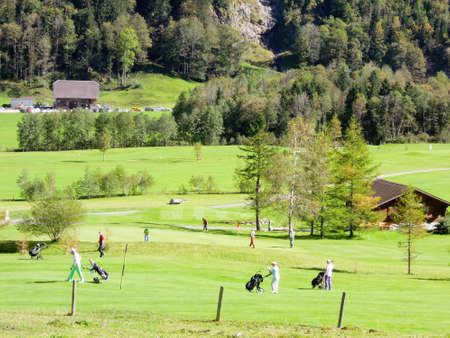 Engelberg, Switzerland - 29 September 2014: People walking an playing on the golf course at Engelberg on the Swiss alpsのeditorial素材