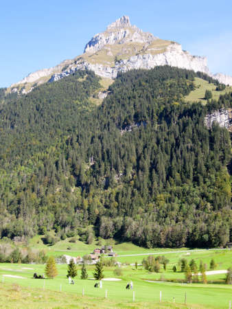 Engelberg, Switzerland - 29 September 2014: People walking an playing on the golf course at Engelberg on the Swiss alpsのeditorial素材