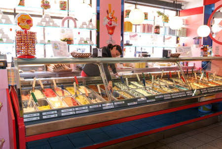 Locarno, Switzerland: 6 april 2010: seller of ice cream that is preparing an ice cream coneのeditorial素材