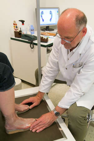 Locarno, Switzerland: 4 May 2010: Doctor preparing orthopedic insoles for a patient on his studioのeditorial素材