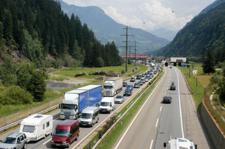 Airolo, Switzerland - 4 August 2008: vehicles waiting in line for entering Gotthard tunnel on the Swiss alpsのeditorial素材