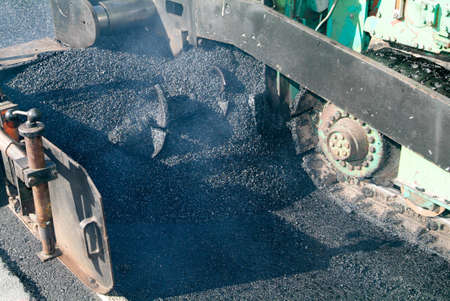 Workers and vehicles during the asphalting of the highway at Bissone on Switzerlandのeditorial素材