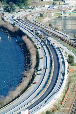 Bissone Switzerland  2 March 2007: Workers and vehicles during the asphalting of the highway at Bissone on Switzerlandのeditorial素材