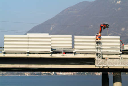 Bissone Switzerland  14 March 2007: Workers during the installation of noise barriers on the highway at Bissone on Switzerland on Switzerlandのeditorial素材