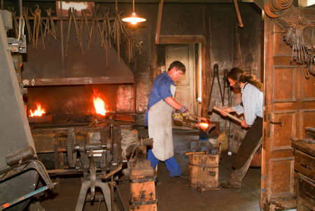 Ballenberg, Switzerland - 14 July 2005: Two blacksmith working in the smithy at Ballenberg, a Swiss...