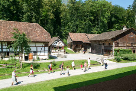 Ballenberg, Switzerland - 14 July 2005: People visiting on walking old farm houses in Ballenberg, a Swiss open-air museum in Brienz, Switzerlandのeditorial素材