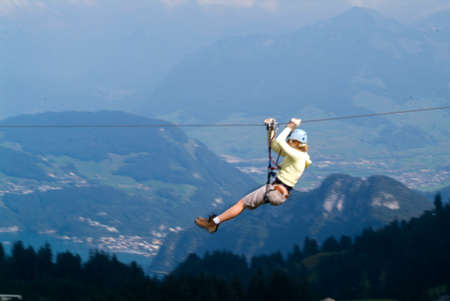 Mount Pilatus, Switzerland - 23 August 2006: Visitors in adventure park clambering with ropes wear protective helmetsのeditorial素材