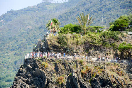 Manarola, Italy - 7 July 2015: people walking to the viewpoint at the village of Manarola on Cinque...