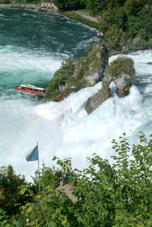 Neuhausen, Switzerland - 26 August 2008: People enjoying the view at the top of the rock that stands in the middle of the Rhine waterfalls at Neuhausen on Switzerlandのeditorial素材