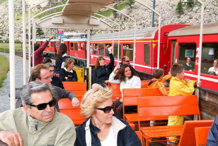 Bernina Express, Switzerland - 21 July 2015: People sitting on the Bernina express train and admiring the scenic view on the Swiss alpsのeditorial素材