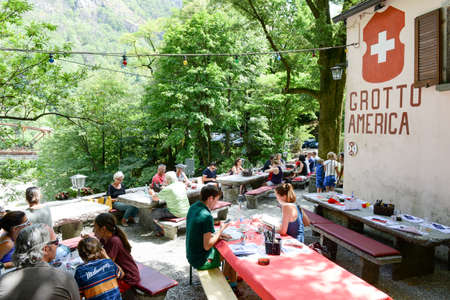 Ponte Brolla, Switzerland - 30 July 2015: People eating on a Grotto, a typical restaurant on the italian part of Switzerland at Ponte Brolla on Maggia valleyのeditorial素材