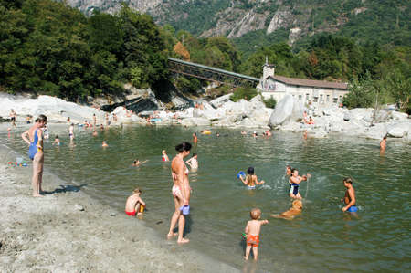 Ponte Brolla, Switzerland - 12 August 2002: People swimming and sunbathing on maggia river at Ponte Brolla on the Swiss alpsのeditorial素材