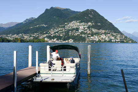 Lugano, Switzerland - 6 September 2015: A taxi boat embarks its customers to bring them on a tour of Lake Luganoのeditorial素材