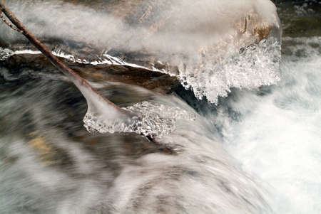 Winter landscape of frozen cascade on the swiss alpsの写真素材