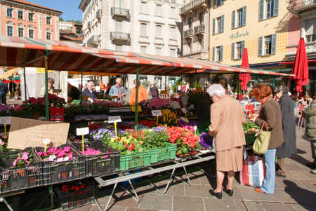 Lugano, Switzerland - 26 April 2005: People shopping flowers at the pedestrian square in the center of Lugano on the italian part of Switzerlandのeditorial素材