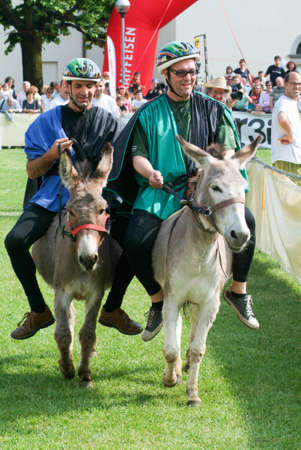 Mendrisio, Switzerland - 29 May 2010: People riding a donkey during the annual competition at Mendrisio on the italian part of Switzerlandのeditorial素材