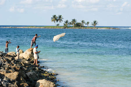 Las Galeras, Dominican Republic - 23 january 2002: fisherman throwing a fishing net into the sea at Las Galeras on Dominican Republicのeditorial素材