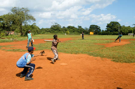 Las Gasleras, Dominican Republic - 24 january 2002: Boys playing baseball on a field at Las Galeras on Dominican Republicのeditorial素材